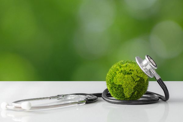 Green globe with a stethoscope wrapped around it